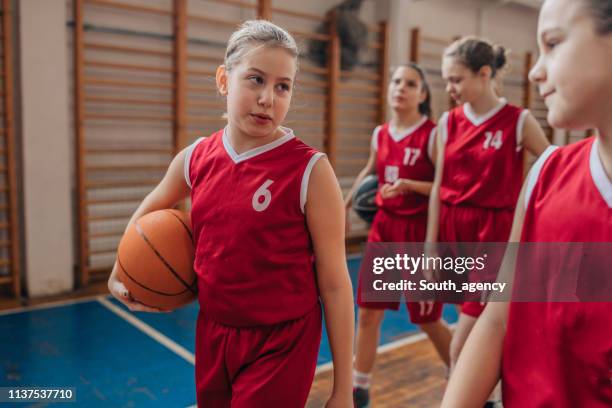 young girls basketball players on court indoors - basketball league stock pictures, royalty-free photos & images