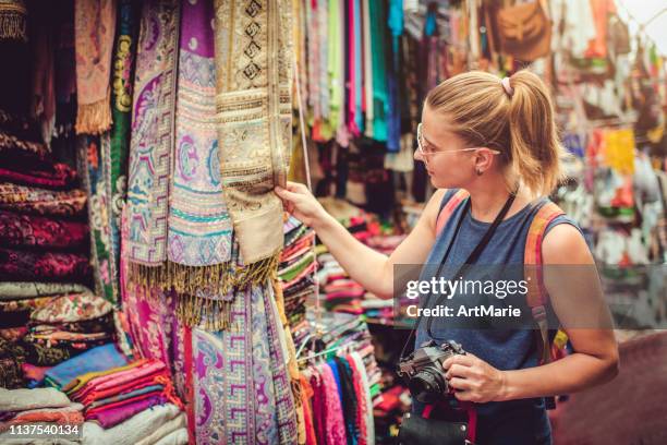 young happy woman discovers gifts market while travelling - middle east market stock pictures, royalty-free photos & images