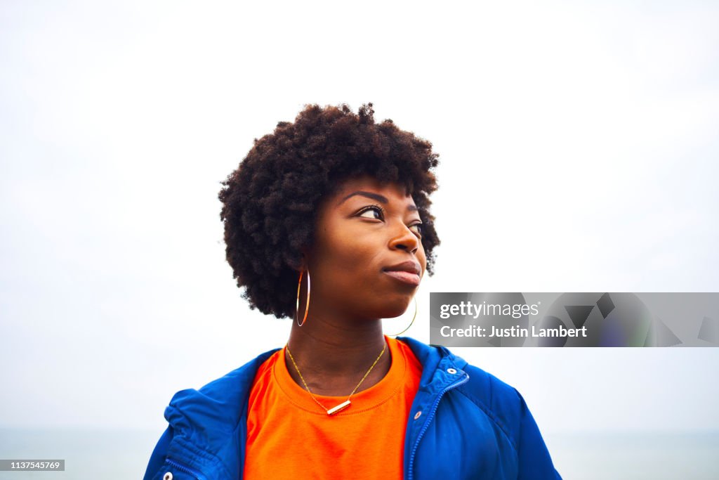 Portrait of woman looking off camera with colourful clothing