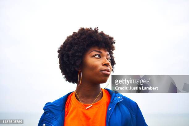portrait of woman looking off camera with colourful clothing - bright colour stock pictures, royalty-free photos & images