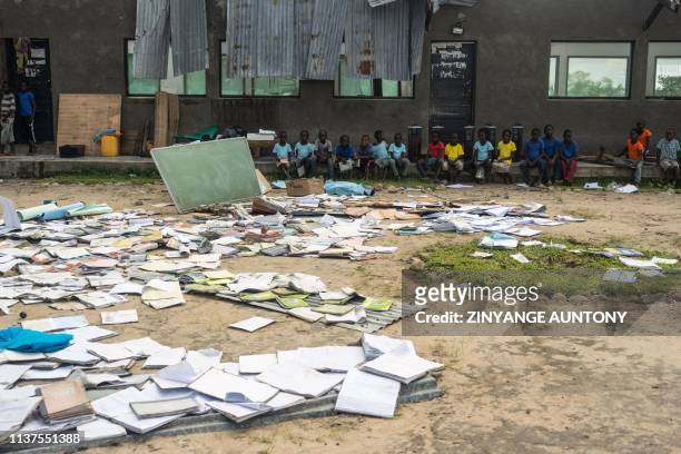 Books are spread on the school grounds to dry at Guara-Guara Primary School, Buzi District, on April 15, 2019. - Cyclone Idai devastated much...