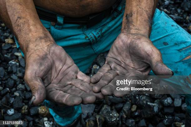 Soot covers the hands of an independent miner, known as a guaquero, in the town of San Pablo de Borbur, Boyaca department, Colombia, on Wednesday,...