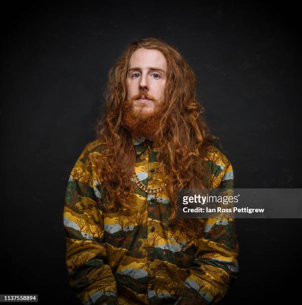 long haired bearded hipster on dark background - langer bart stock-fotos und bilder