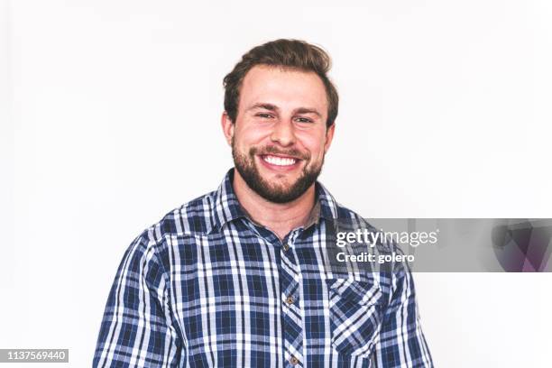 happy young strong bearded man - plaid lumberjack shirt stock pictures, royalty-free photos & images