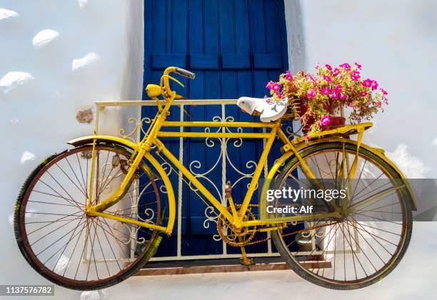 yellow bike in naxos, naxos, cyclades islands, greece - templo de apolo naxos imagens e fotografias de stock