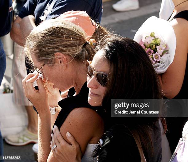 Family members of the victims of the September 11 terror attacks console one another during the ceremony to commemorate the fourth anniversary of the...