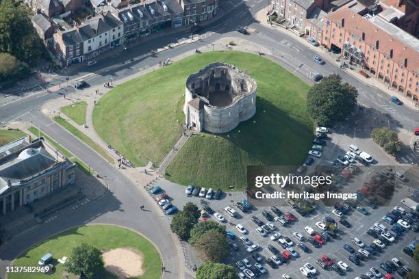 York Castle and Clifford's Tower, North Yorkshire, 2014. Clifford's Tower is the keep of the former York castle. The present stone keep was built on...