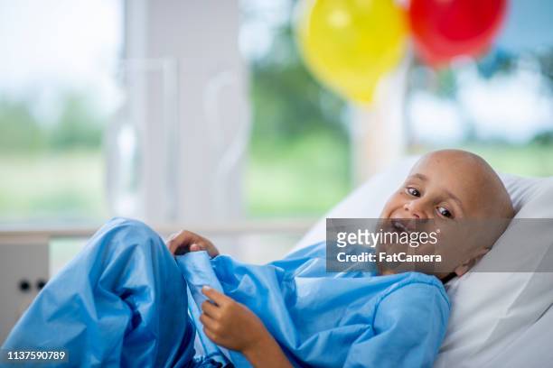young boy in hospital laughing - childhood cancer stock pictures, royalty-free photos & images