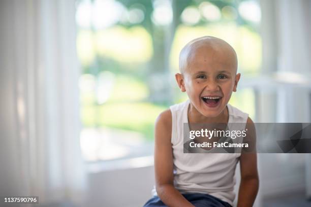 keeping up hope - bald child stock pictures, royalty-free photos & images