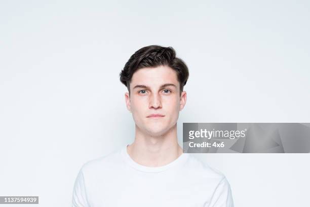 close up view of attractive man wearing white t-shirt - caucasian man face stock pictures, royalty-free photos & images