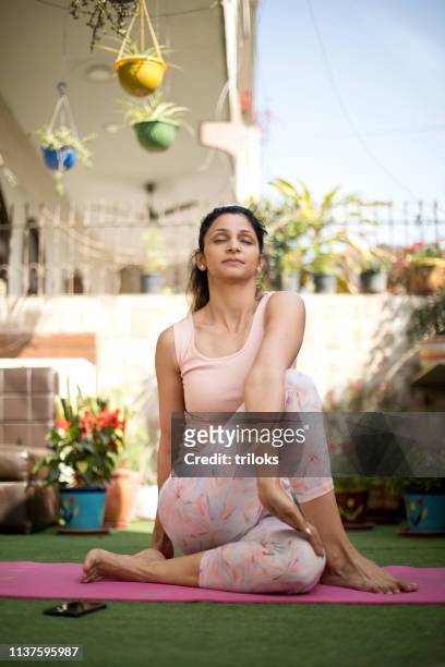 woman in yoga pose outdoor - yoga stock pictures, royalty-free photos & images