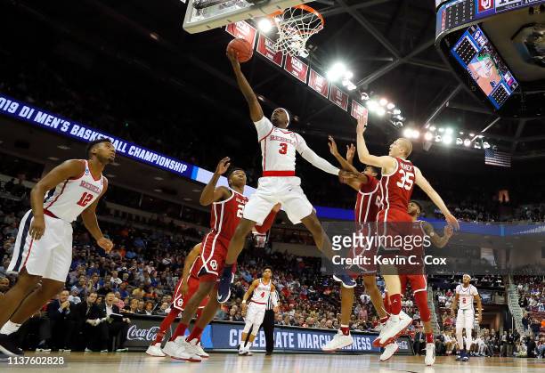 Terence Davis of the Mississippi Rebels drives to the basket against Brady Manek of the Oklahoma Sooners in the first half during the first round of...