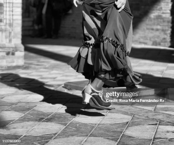 low section view of woman (flamenco dancer) tap dancing in street, sevilla, andalusia, spain - flounced skirt stock pictures, royalty-free photos & images