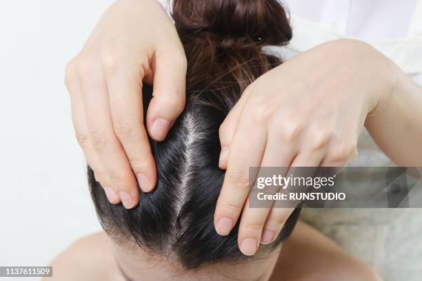 dermatologist examining patient's scalp - damaged hair stock pictures, royalty-free photos & images