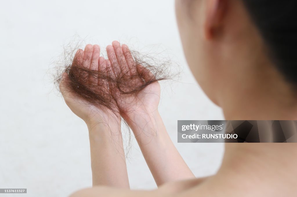 Woman Looking At Loss Hair