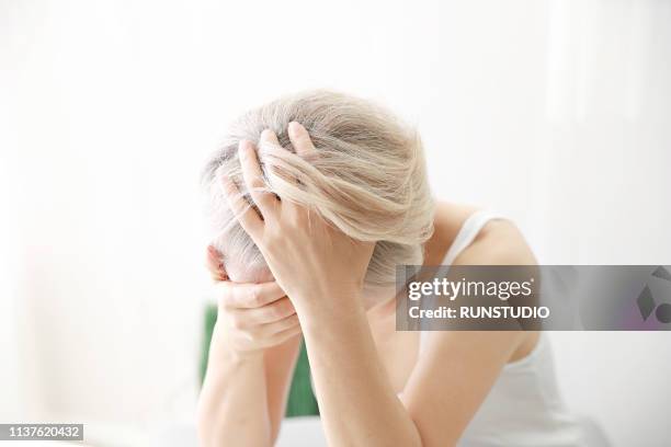 worried senior woman with hair loss - gray hair stress stock pictures, royalty-free photos & images