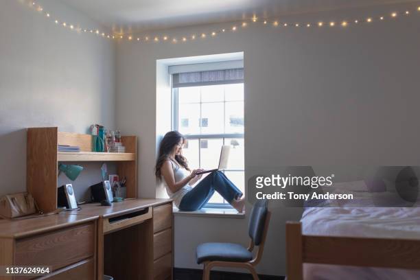 young woman college student in her dorm room with laptop - 寮の部屋 ストックフォトと画像