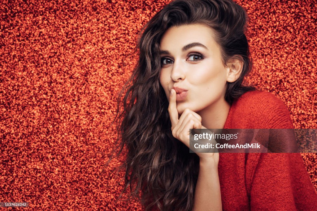 Beautiful girl. Red background. Great mood.