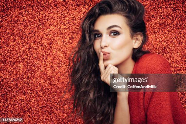 beautiful girl. red background. great mood. - beautiful woman stock pictures, royalty-free photos & images