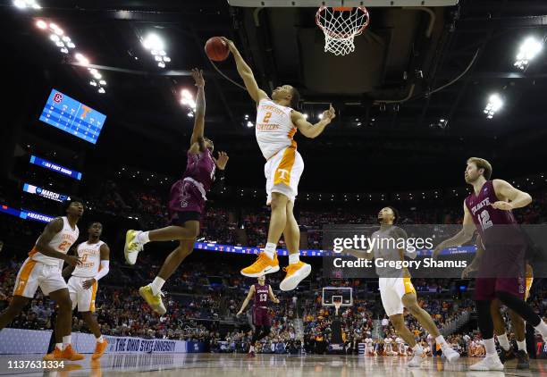 Grant Williams of the Tennessee Volunteers blocks a shot by Jordan Burns of the Colgate Raiders during the second half in the first round of the 2019...