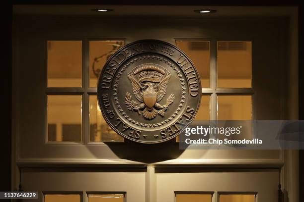 The presidential seal hangs above the door to the White House West Wing shortly after special counsel Robert Mueller delivered his report on Russian...