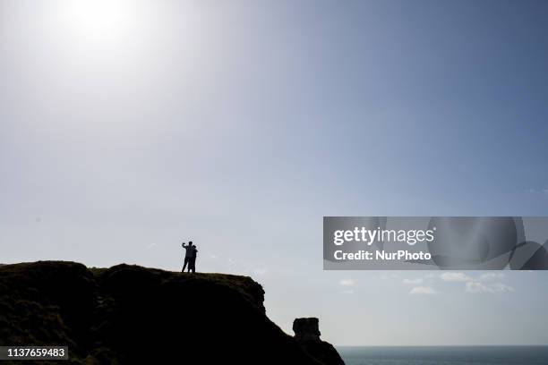 Etretat, Normandy, France, March 25, 2019. Two people selfie from the D aval Cliff in good weather. Etretat, Normandie, France, le 25 mars 2019. Deux...