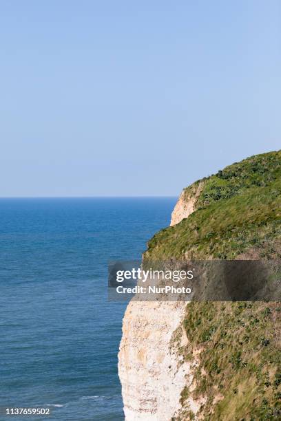 Etretat, Normandy, France, March 25, 2019. The cliff of Aval in good weather. An underground river, followed by marine erosion, formed a natural arch...