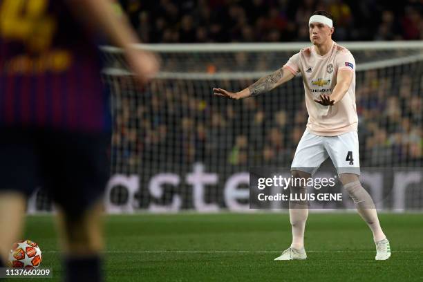 Manchester United's English defender Phil Jones gestures during the UEFA Champions League quarter-final second leg football match between Barcelona...