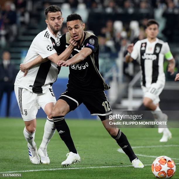 Juventus' Bosnian midfielder Miralem Pjanic holds off Ajax's Dutch defender Noussair Mazraoui during the UEFA Champions League quarter-final second...