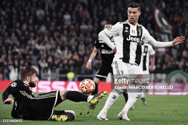 Ajax's Danish midfielder Lasse Schone tackles Juventus' Portuguese forward Cristiano Ronaldo during the UEFA Champions League quarter-final second...