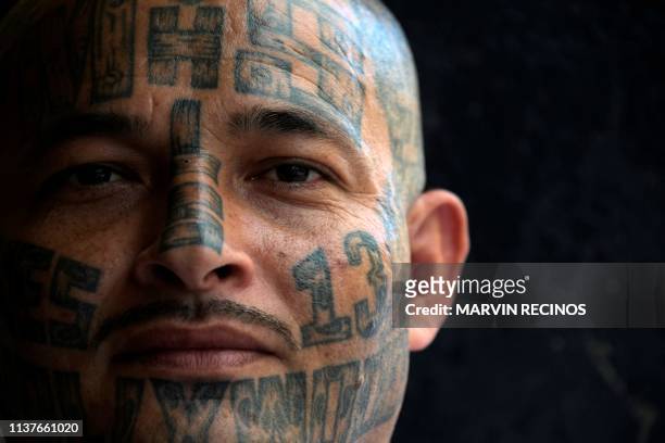 Member of the MS-13 gang is portrayed in Chalatenango prison, 84 km north of San Salvador, on March 29, 2019. - Central American countries bear a...