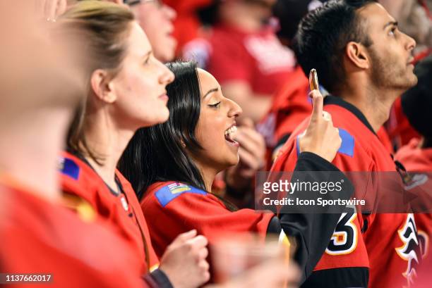 Calgary Flames fans celebrate a goal during the third period of Game Two of the Western Conference First Round during the 2019 Stanley Cup Playoffs...