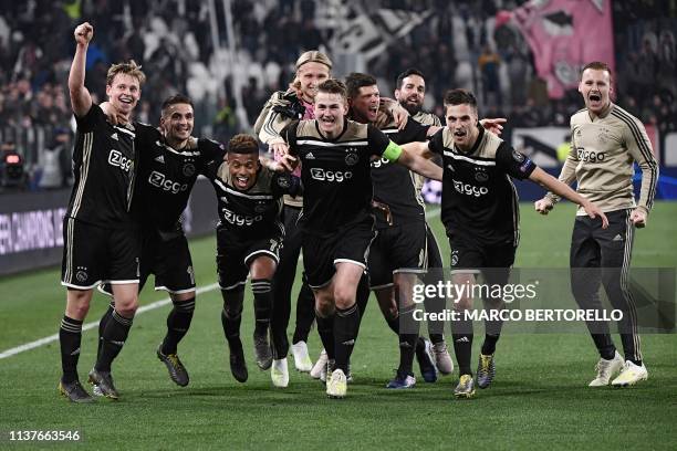 Ajax's Dutch midfielder Frenkie de Jong and teammates celebrate after defeating Juventus during the UEFA Champions League quarter-final second leg...