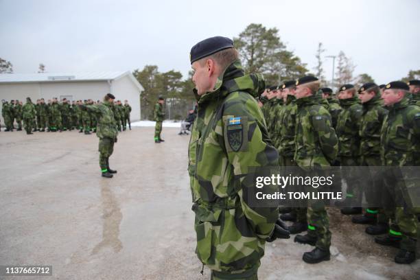 Soldiers stand on parade at a base near the town of Visby on February 5 as part of a ceremony commemoration the foundation of the Gotland Regiment. -...