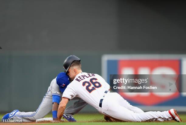 Alen Hanson of the Toronto Blue Jays catches Max Kepler of the Minnesota Twins attempting to advance to second base on a fly ball during the first...