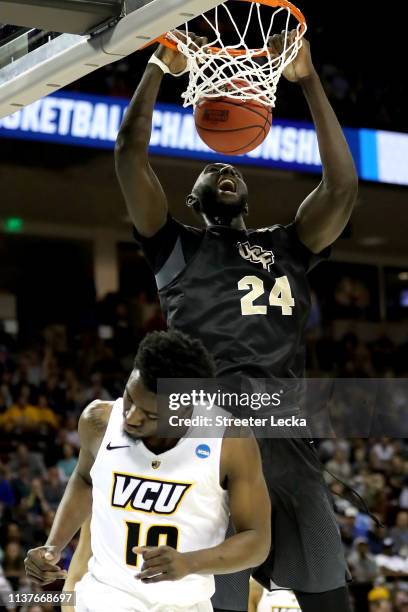 Tacko Fall of the UCF Knights dunks the ball against Vince Williams of the Virginia Commonwealth Rams in the first half during the first round of the...