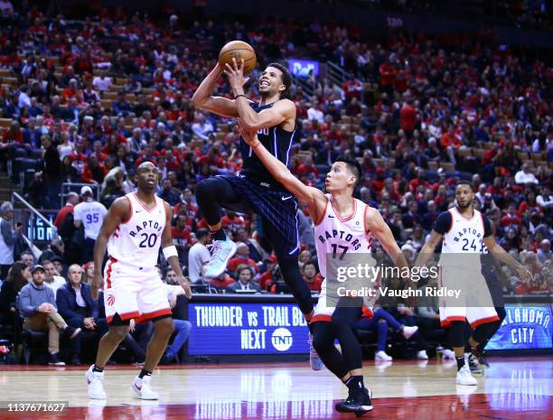 Michael Carter-Williams of the Orlando Magic shoots the ball as Jeremy Lin of the Toronto Raptors defends during Game Two of the first round of the...