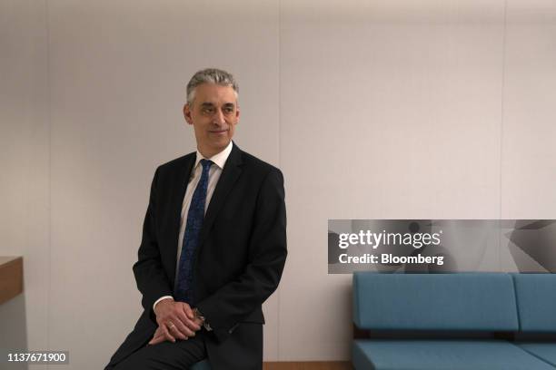 Frank Appel, chief executive officer of Deutsche Post AG, poses for a photograph before a Bloomberg Television interview in Singapore, on Wednesday,...