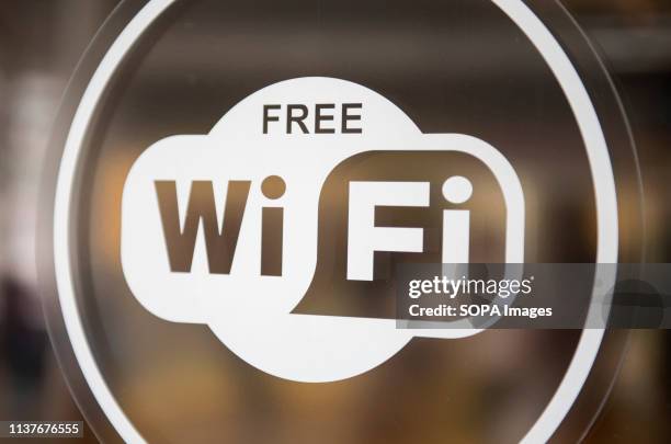 Glass sticker announcing to customers the availability of free WI-FI Internet usage is seen at a shopping mall in Hong Kong.