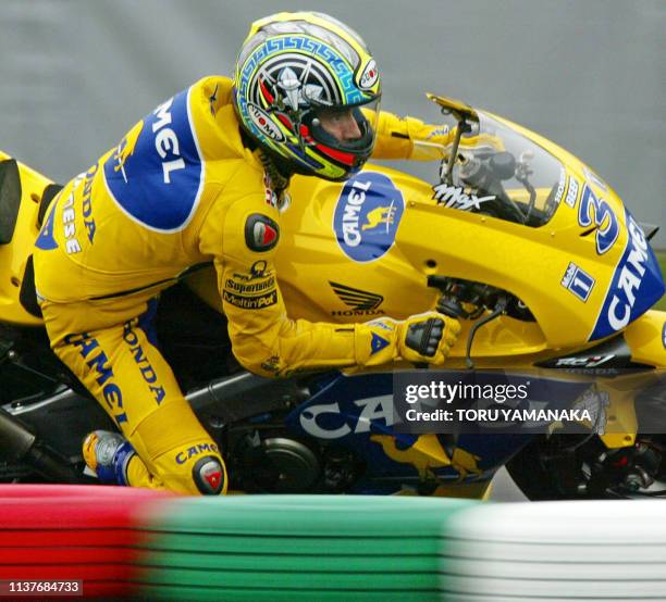 Max Biaggi of Italy powers his Honda during the qualifying practice session for the motorcycle Grand Prix of Japan in Suzuka, central Japan, 04 April...