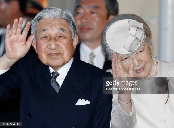 Japan's Emperor Akihito and Empress Michiko wave to well-wishers upon their arrive at Ujiyamada Station for a visit to Ise Jingu shrine, ahead of his...