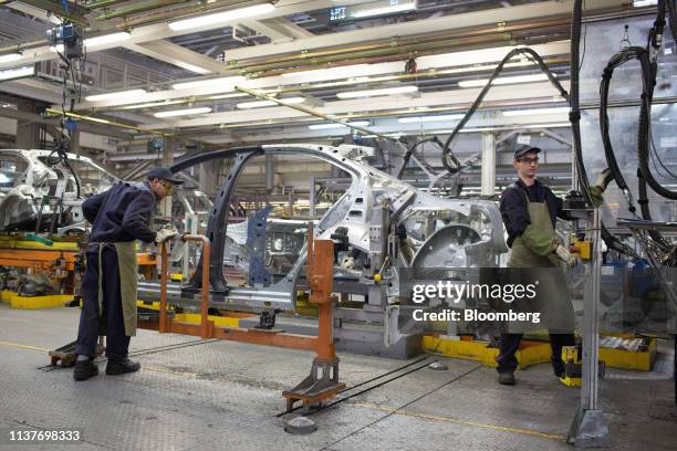 Workers prepare the structural body panel for a Skoda Kodiaq automobile at the early stages of assembly at the GAZ Group plant in Nizhny Novgorod,...