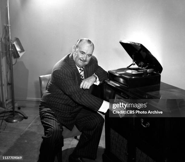 Radio band leader Paul Whiteman, listens to the quality of long playing micro-groove music records. June 1, 1948.