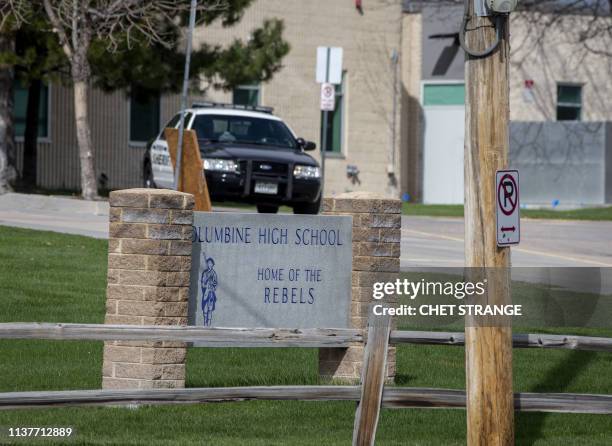 Police patrol outside a locked Columbine High School on April 17, 2019 in Littleton, Colorado, as all Denver-area schools were evacuated and classes...