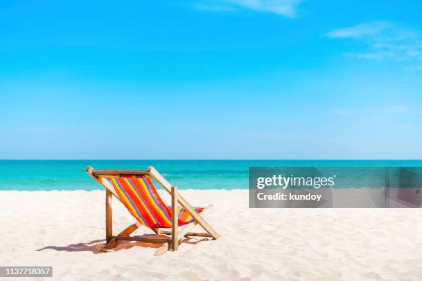 beach chair on the white sand with blue sky and summer sea background. - beach deck chairs stock pictures, royalty-free photos & images