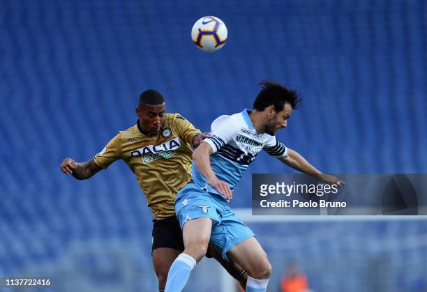 Marco Parolo of SS Lazio competes for the ball with Romeo Zeegelaar of Udinese during the Serie A match between SS Lazio and Udinese at Stadio...