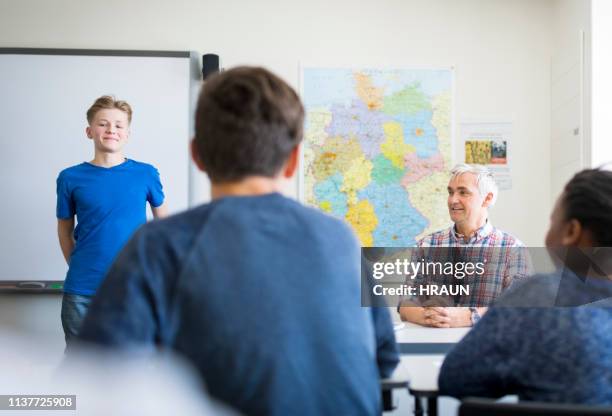 teacher and students smiling in classroom - boy in briefs stock pictures, royalty-free photos & images