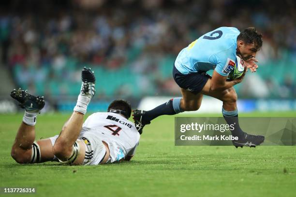 Nick Phipps of the Waratahs evades the diving Quinten Strange of the Crusaders during the round six Super Rugby match between the Waratahs and the...