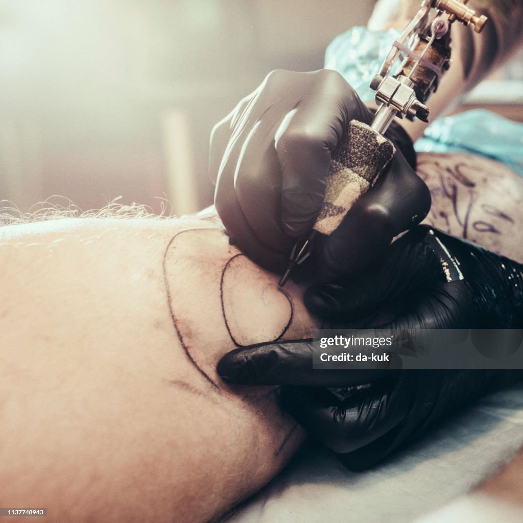 Tattoo Master Making Tattoo On Leg High-Res Stock Photo - Getty Images