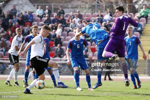 Jannis Lang of Germany U17 tries to score past goalkeeper Olafur Kristofer Helgason of Iceland U17 during the UEFA Elite Round match between Germany...